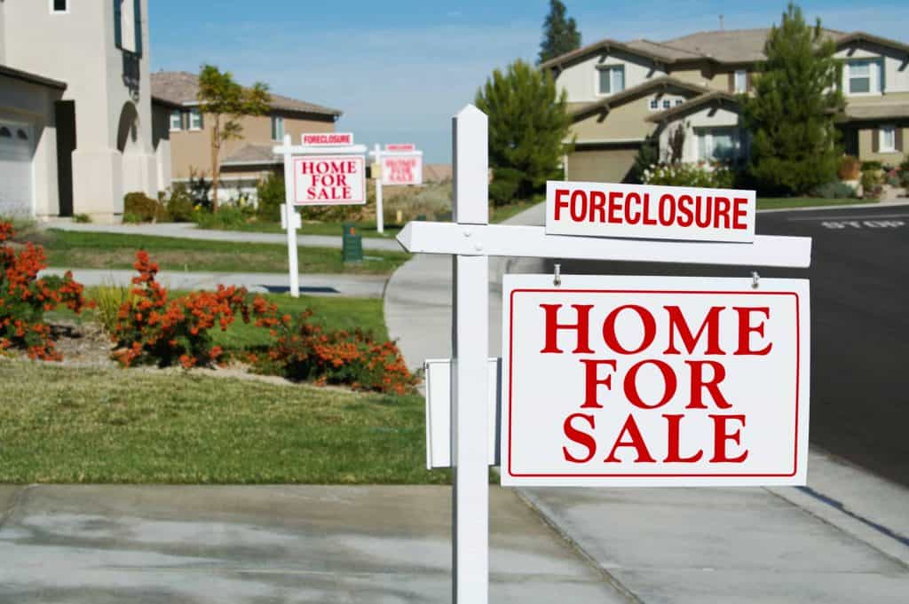 Foreclosure sign on home for sale.
