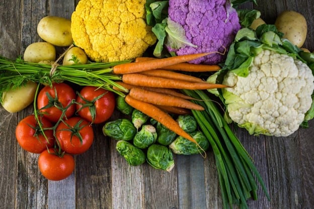 Colorful vegetables on a wooden table.