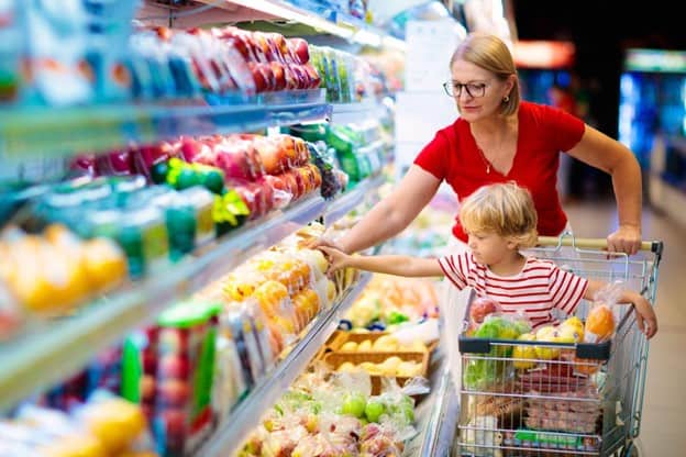 Mother and child shopping for fruit at the grocery store